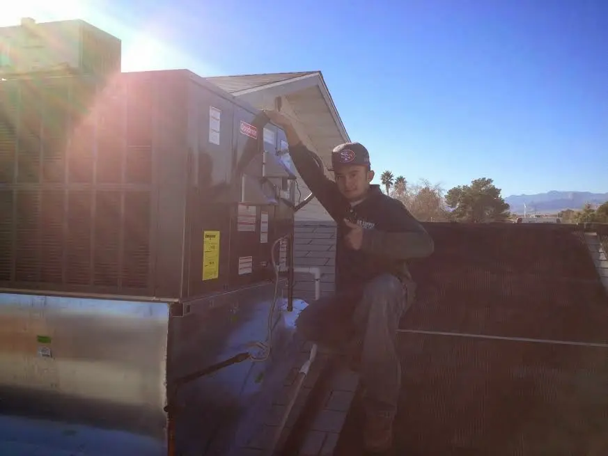HVAC technician performing Boiler Repair on a rooftop unit in Hollywood